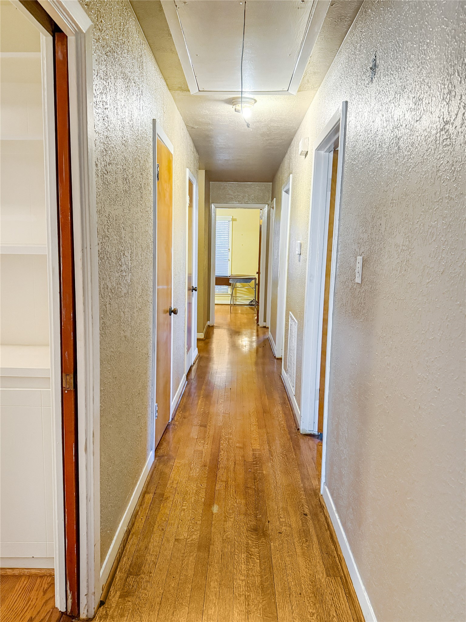 8219 Colgate Street Houston, TX 77061 - Photo 25 of 39 a view of a hallway with wooden floor