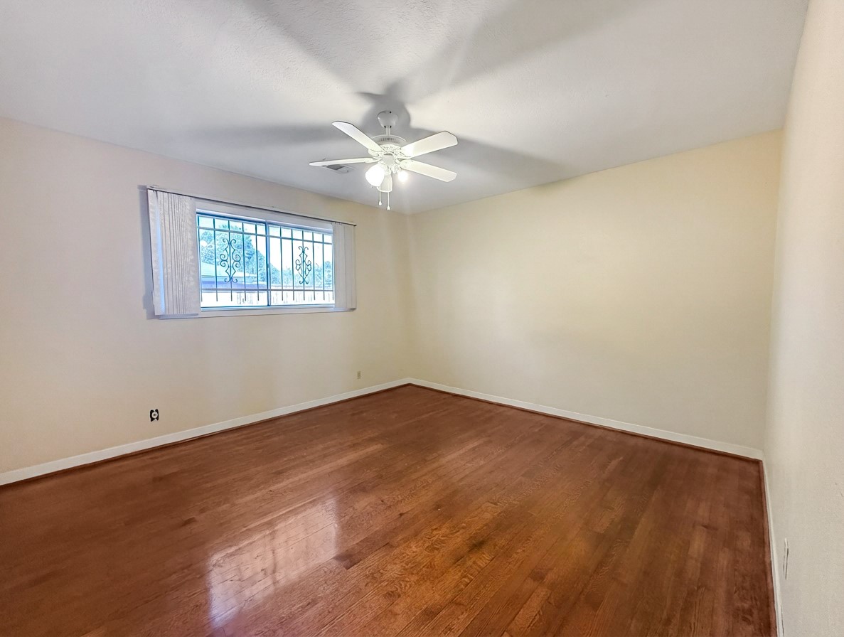 8219 Colgate Street Houston, TX 77061 - Photo 26 of 39 an empty room with windows and fan