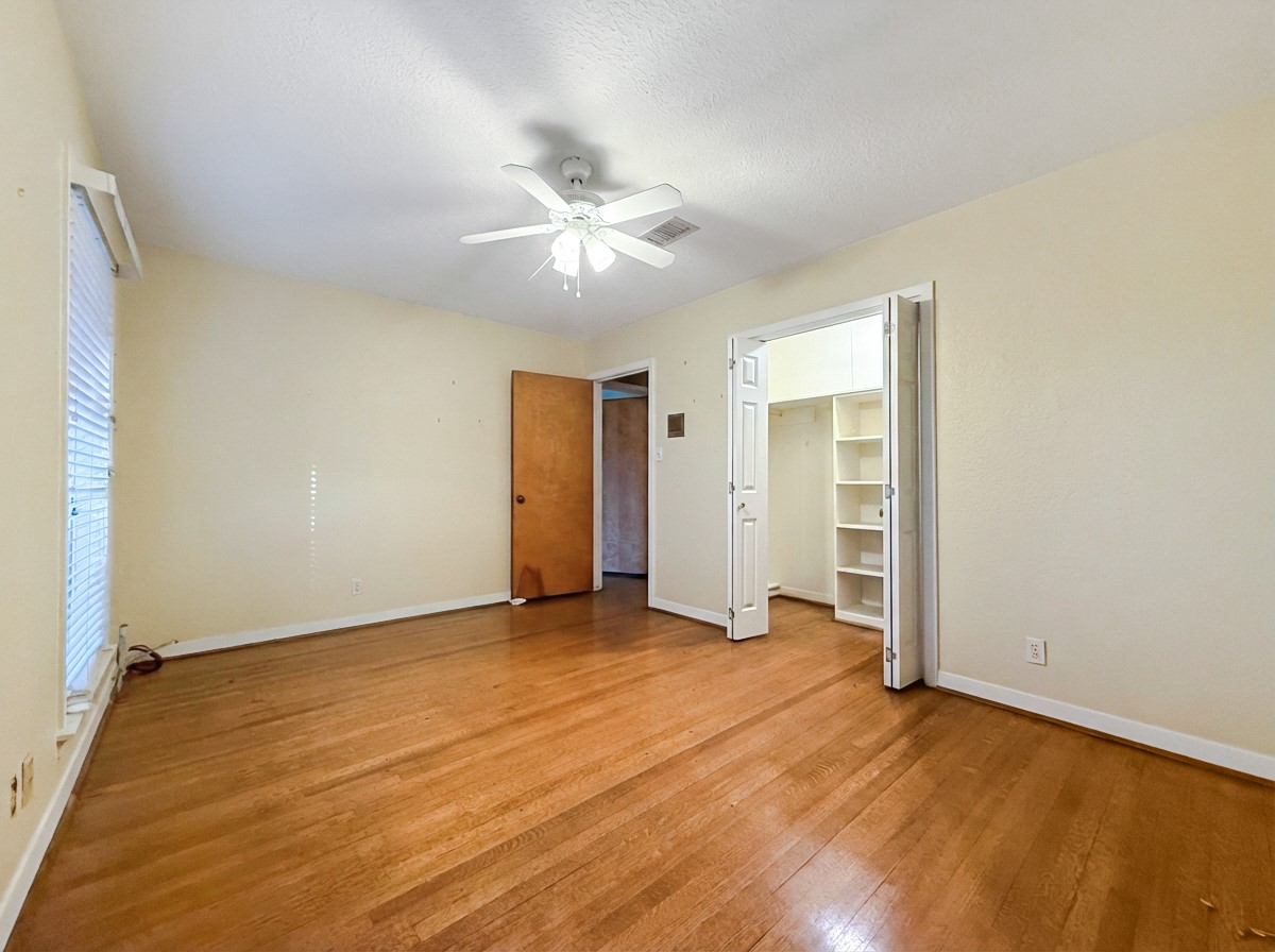 8219 Colgate Street Houston, TX 77061 - Photo 29 of 39 an empty room with closet and a ceiling fan