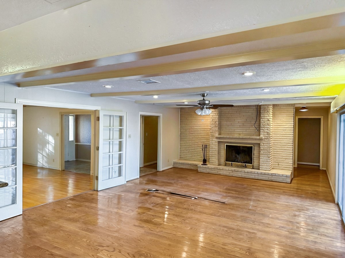 8219 Colgate Street Houston, TX 77061 - Photo 3 of 39 a view of empty room with wooden floor and fireplace
