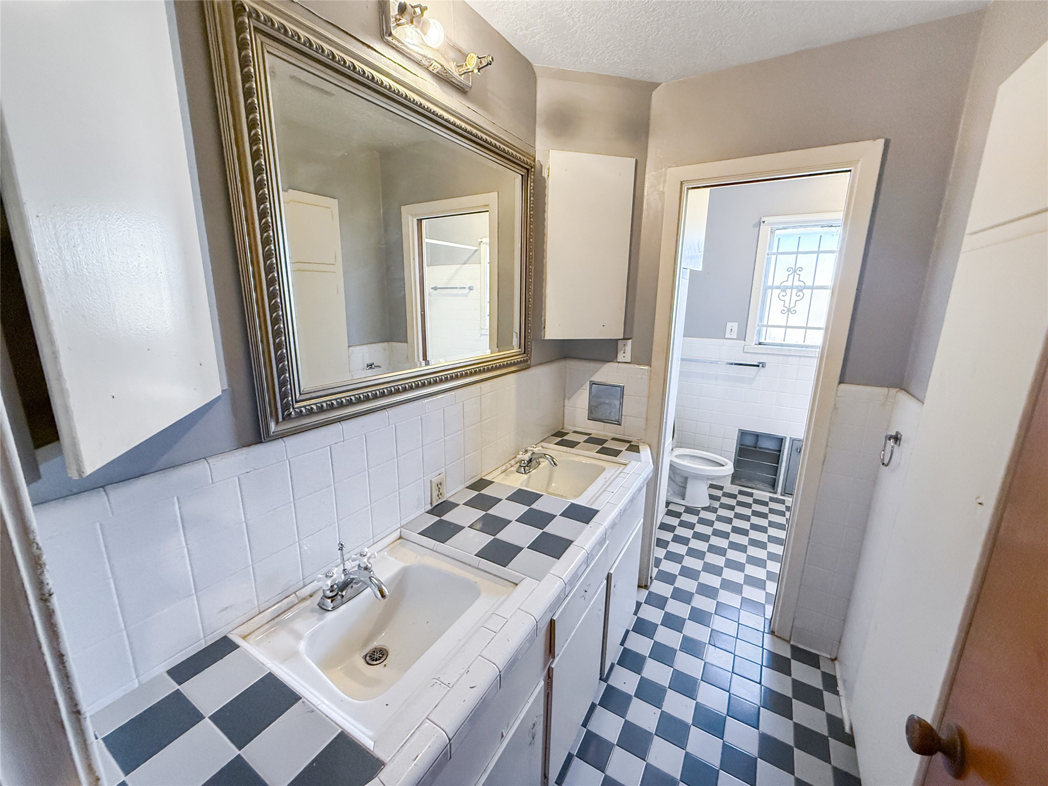 8219 Colgate Street Houston, TX 77061 - Photo 31 of 39 a bathroom with a sink mirror and a toilet