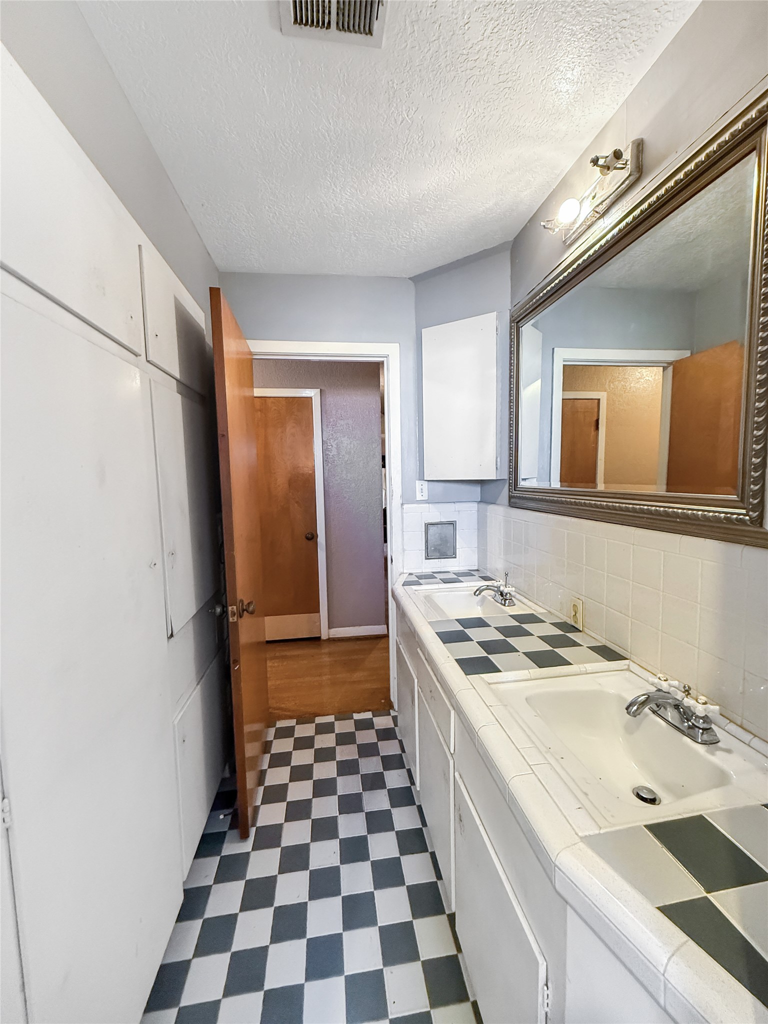 8219 Colgate Street Houston, TX 77061 - Photo 32 of 39 a kitchen with a stove a sink and a refrigerator