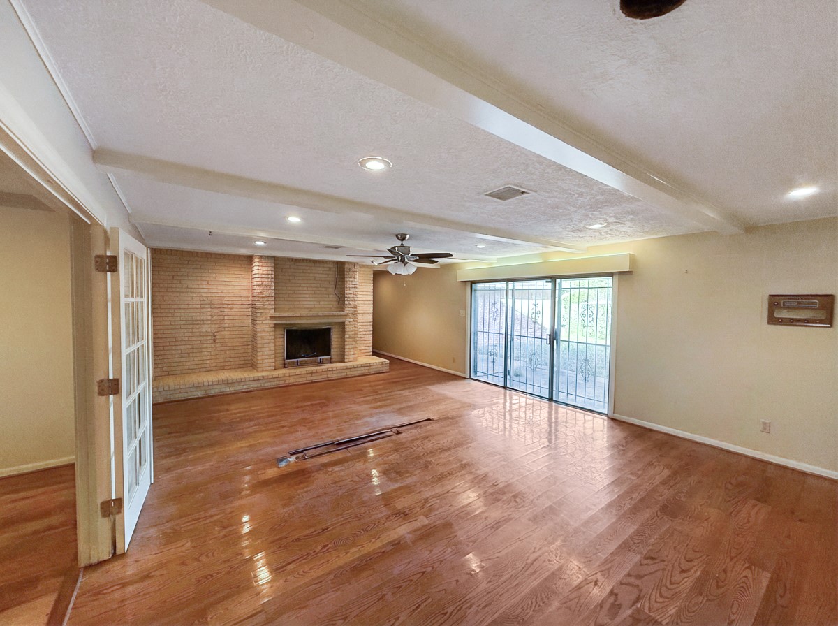 8219 Colgate Street Houston, TX 77061 - Photo 5 of 39 a view of an empty room with a fireplace and a window