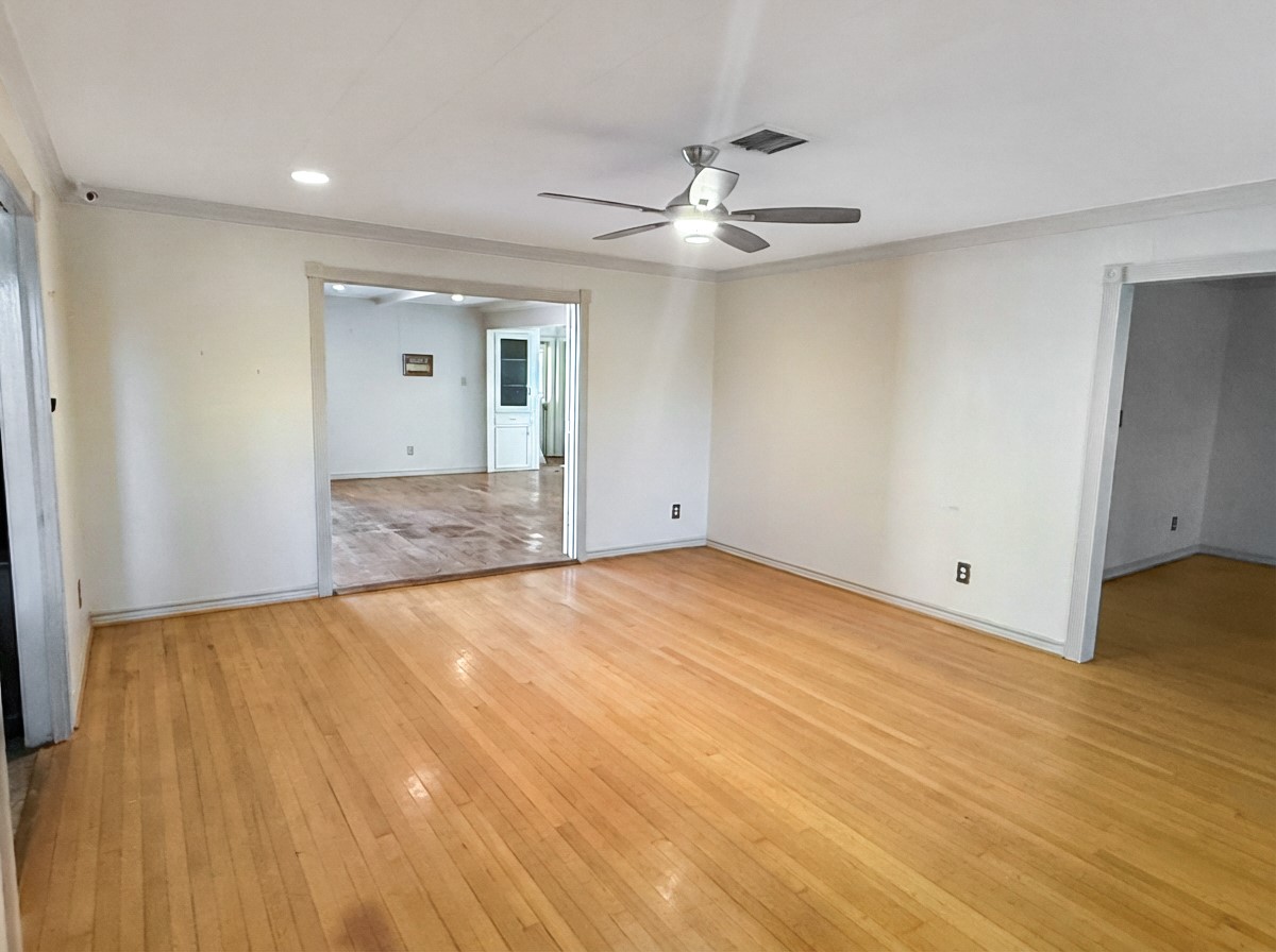 8219 Colgate Street Houston, TX 77061 - Photo 7 of 39 an empty room with wooden floor and windows