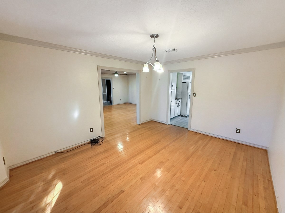 8219 Colgate Street Houston, TX 77061 - Photo 8 of 39 wooden floor in an empty room with a window