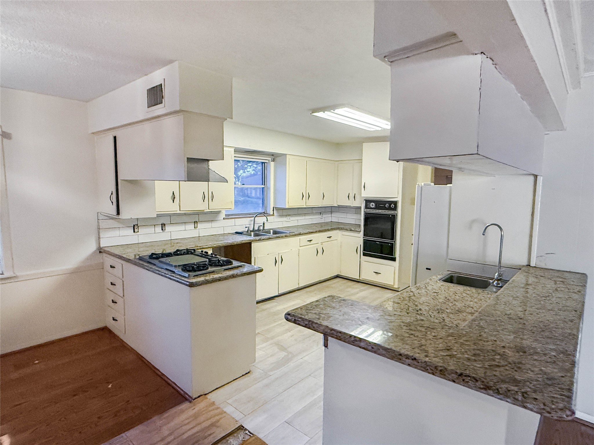 8219 Colgate Street Houston, TX 77061 - Photo 10 of 39 a kitchen with a stove a sink and a refrigerator