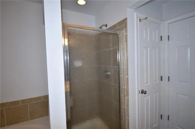 a bathroom with a glass shower door