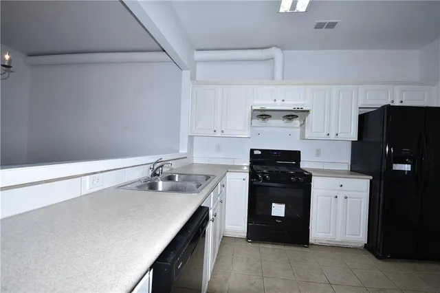 a kitchen with a sink and a refrigerator