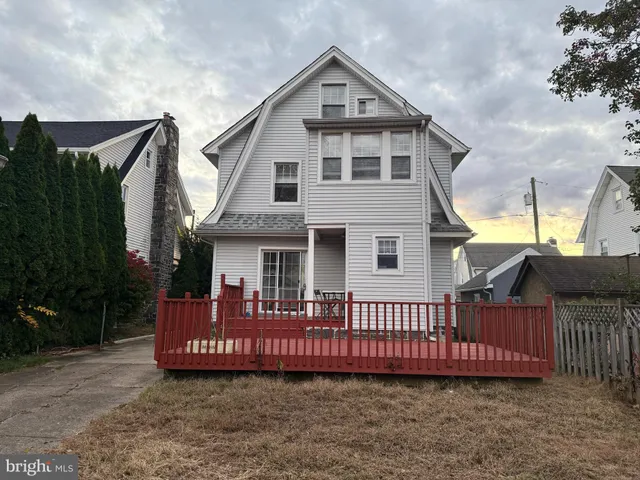 a view of a house with wooden fence