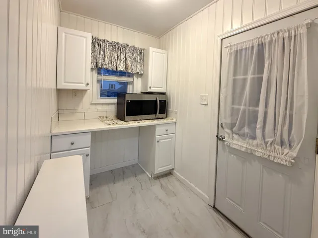 a kitchen with a refrigerator sink and cabinets