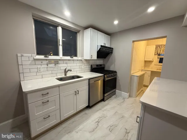 a kitchen with a sink stove and refrigerator