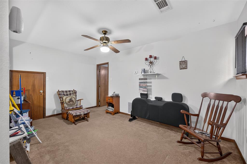 10964 River Ranch Road Kemp, TX 75143 - Photo 35 of 40 Carpeted flooring, white painted walls, wood-finish interior doors, and a ceiling fan with integrated lighting