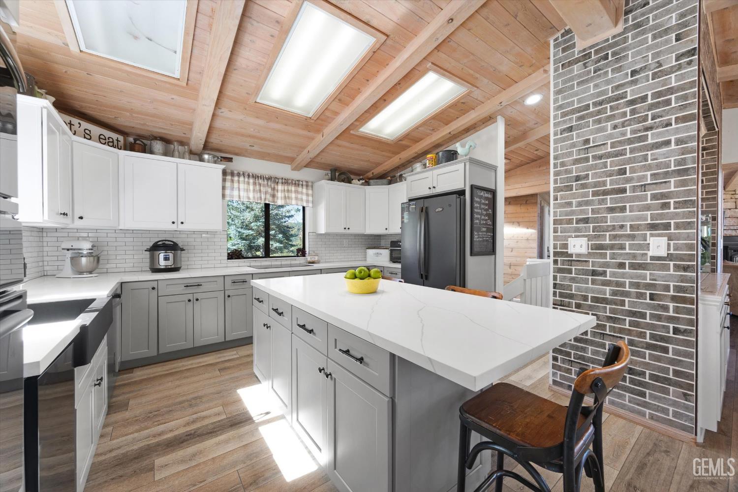 Undisclosed Address Tehachapi, CA 93561 - Photo 20 of 62 a kitchen with a wooden cabinets and white appliances