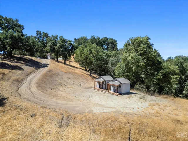 a view of a hallway with a dining table & chairs