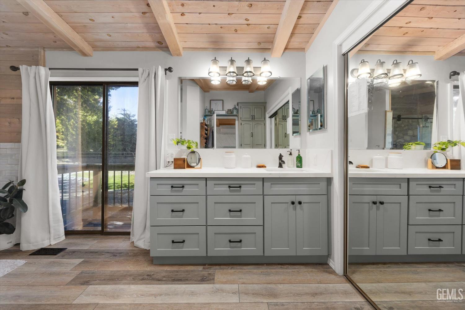 Undisclosed Address Tehachapi, CA 93561 - Photo 38 of 62 a bathroom with a granite countertop sink a large mirror a vanity and a shower