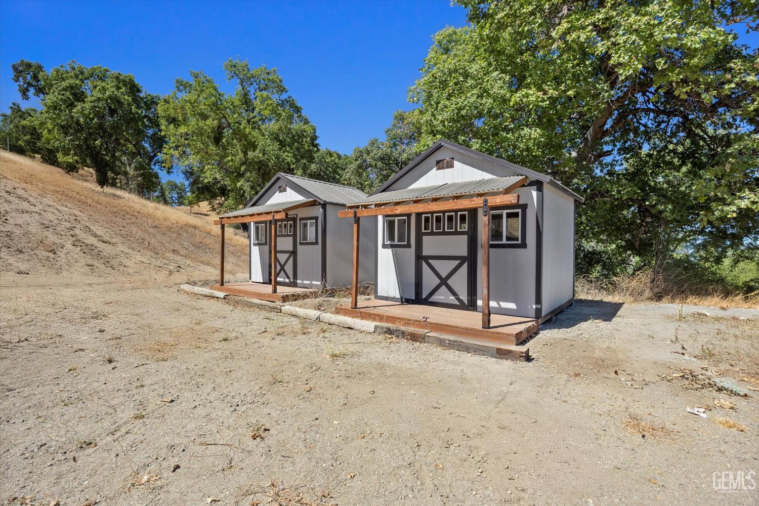 Undisclosed Address Tehachapi, CA 93561 - Photo 60 of 62 a front view of a house with a yard and garage