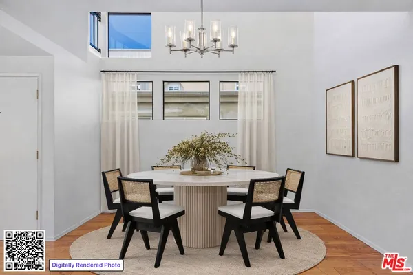 a living room with furniture wooden floor and a dining table
