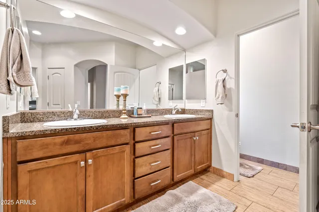a spacious bathroom with a granite countertop sink mirror and a