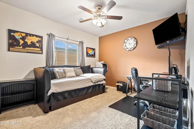 a living room with furniture a flat screen tv and a table