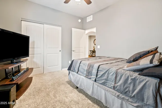 a bedroom with a bed and a flat screen tv