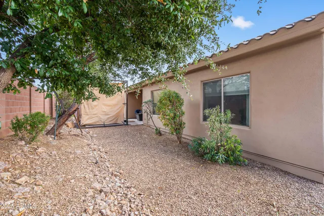 a view of a house with a backyard