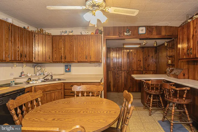 a kitchen with a table chairs sink and cabinets
