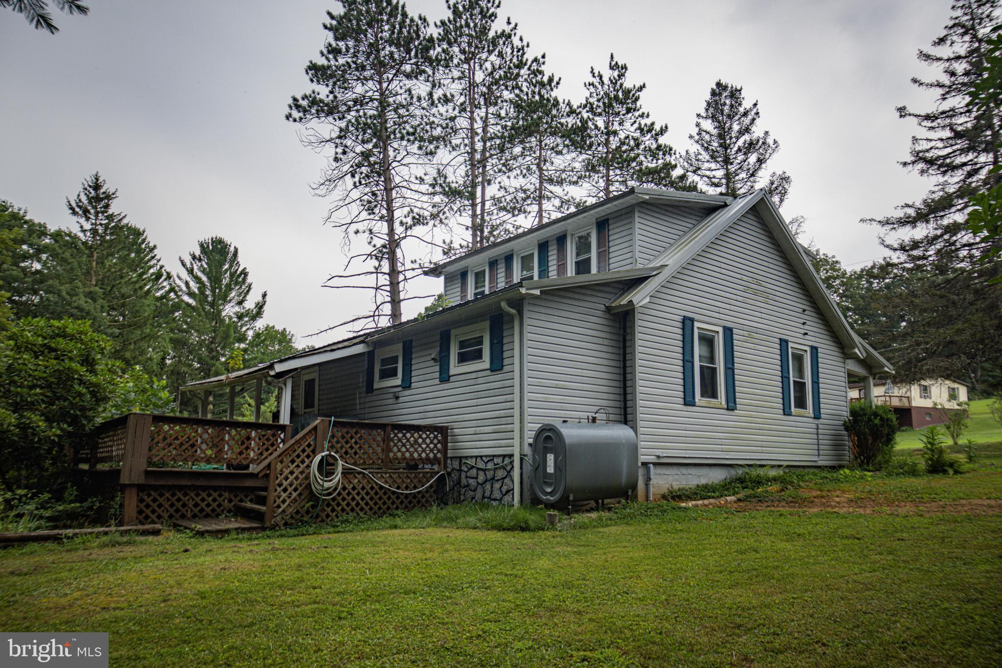 12376 Friendsville Road Friendsville, MD 21531 - Photo 2 of 37 a backyard of a house with table and chairs