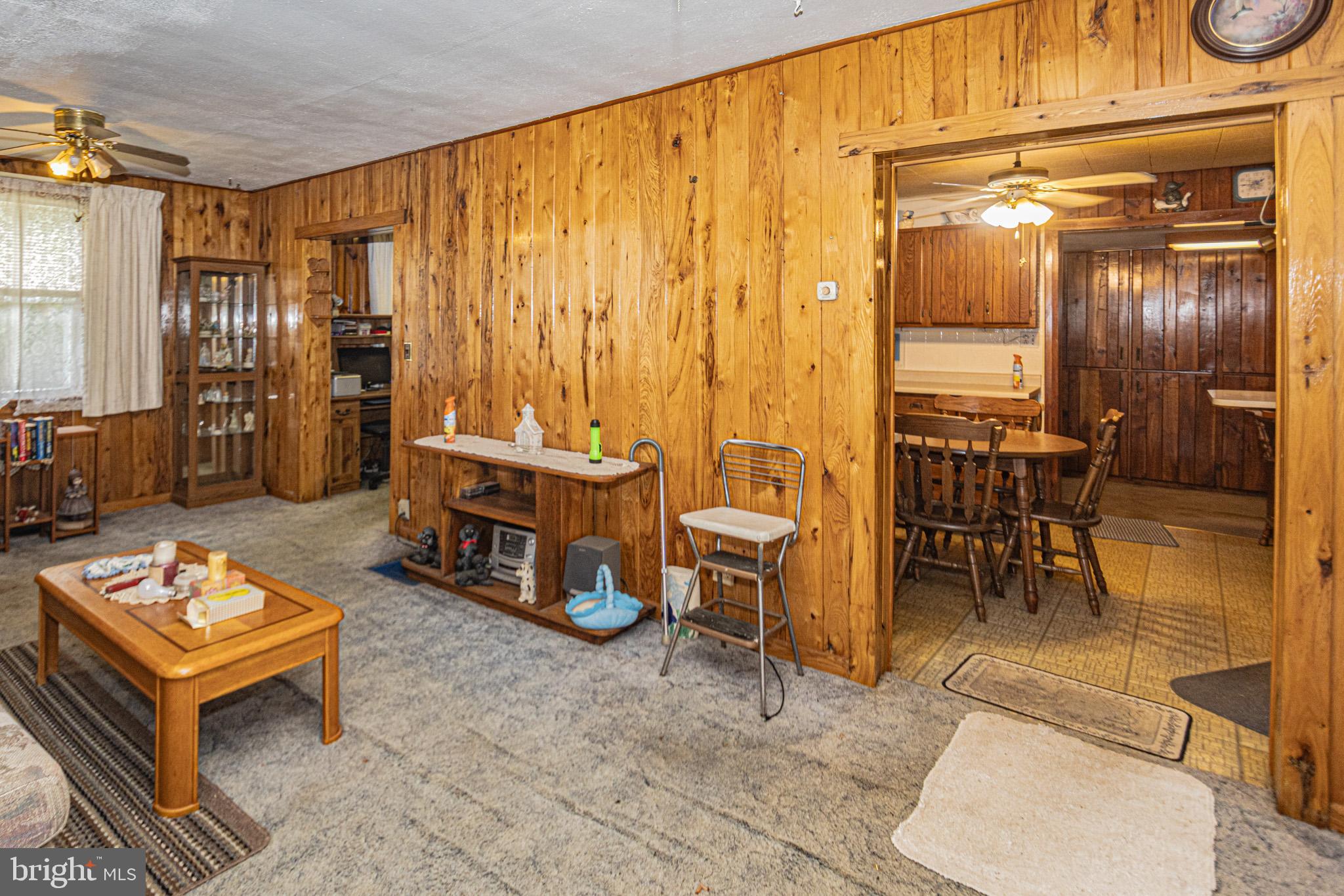12376 Friendsville Road Friendsville, MD 21531 - Photo 22 of 37 a living room with furniture a dining table and chairs with wooden floor