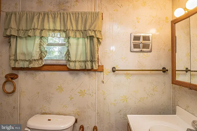 a bathroom with a toilet sink and shower