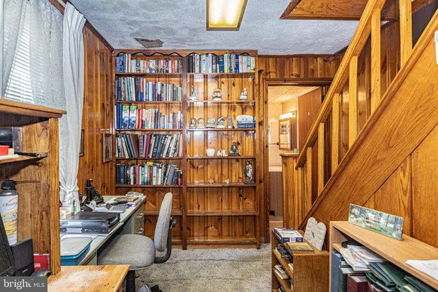 a view of front door with wooden floor and furniture