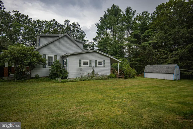 a front view of house with yard and trees