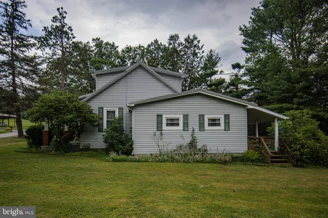 a front view of house with yard and green space