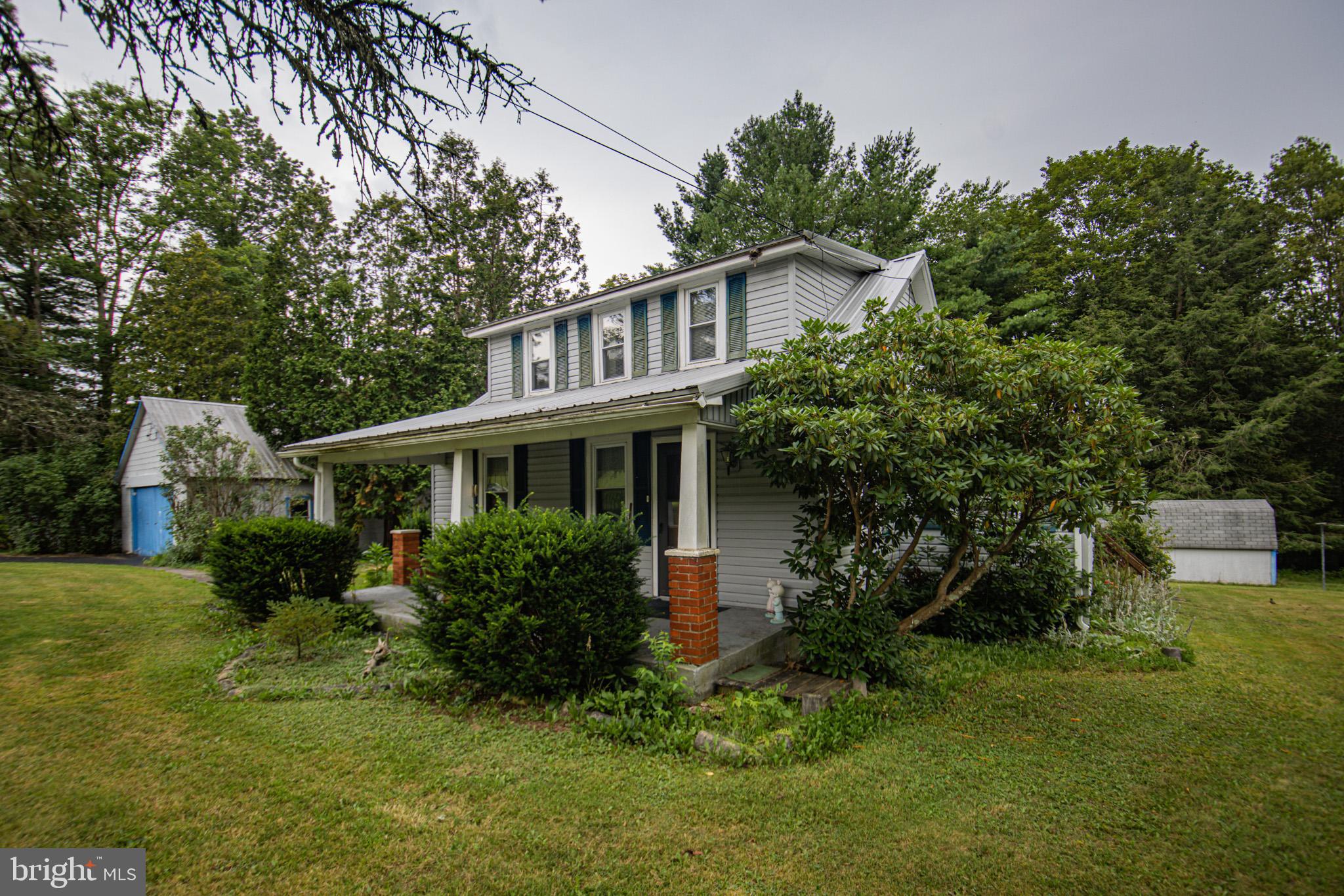 12376 Friendsville Road Friendsville, MD 21531 - Photo 4 of 37 a front view of house with yard and green space