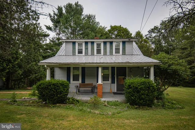 a front view of a house with a yard table and chairs