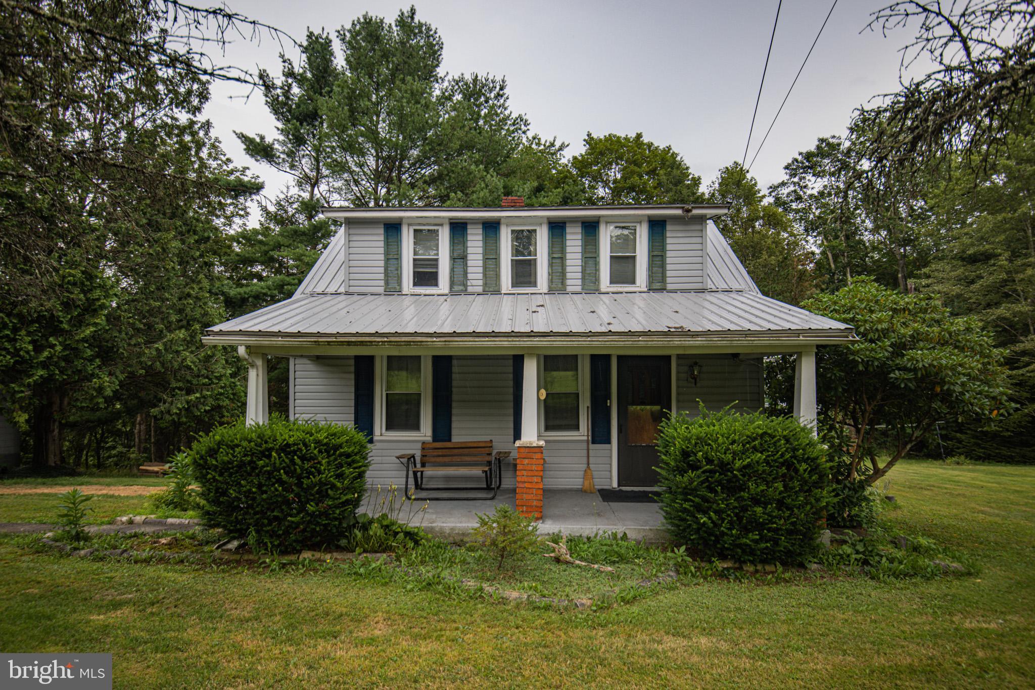 12376 Friendsville Road Friendsville, MD 21531 - Photo 5 of 37 a front view of a house with a yard table and chairs