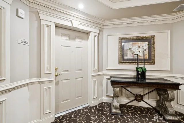 a living room with a table and a potted plant