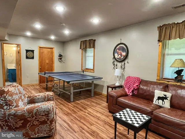 a living room with furniture a rug and a window