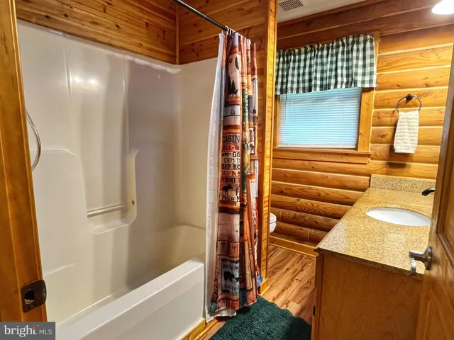 a bathroom with a shower and a sink