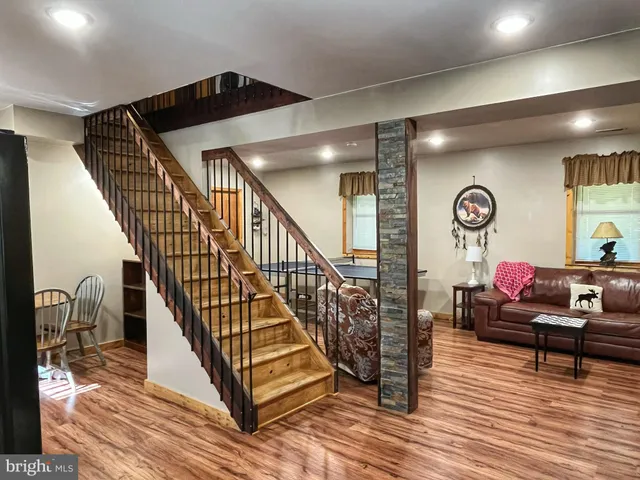 a view of entryway and hall with wooden floor
