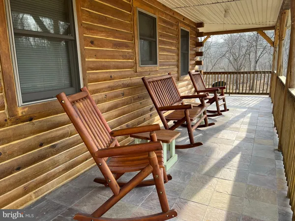 a view of a house with a yard and sitting area