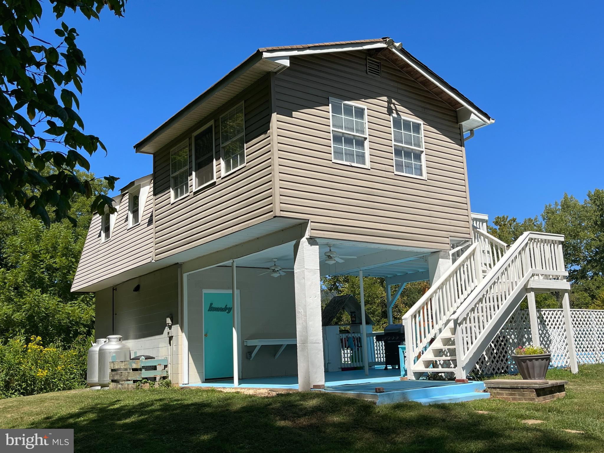 5532 Page Valley Road Luray, VA 22835 - Photo 23 of 42 a view of a white house with a small yard and potted plants