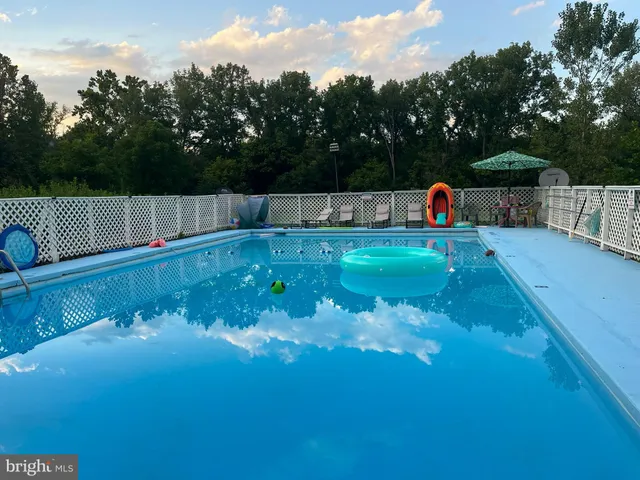 a view of a chairs and table in backyard