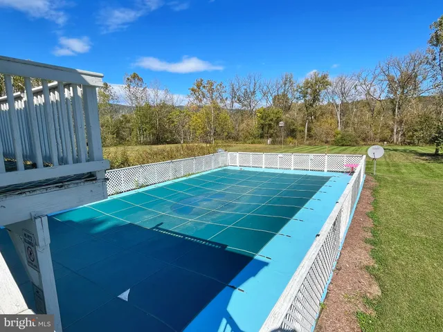 a view of a chair and table in the roof deck