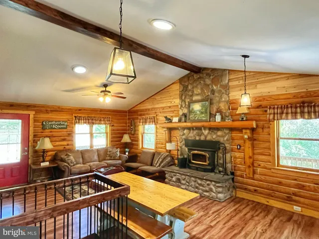 a living room with furniture a fireplace and next to a window