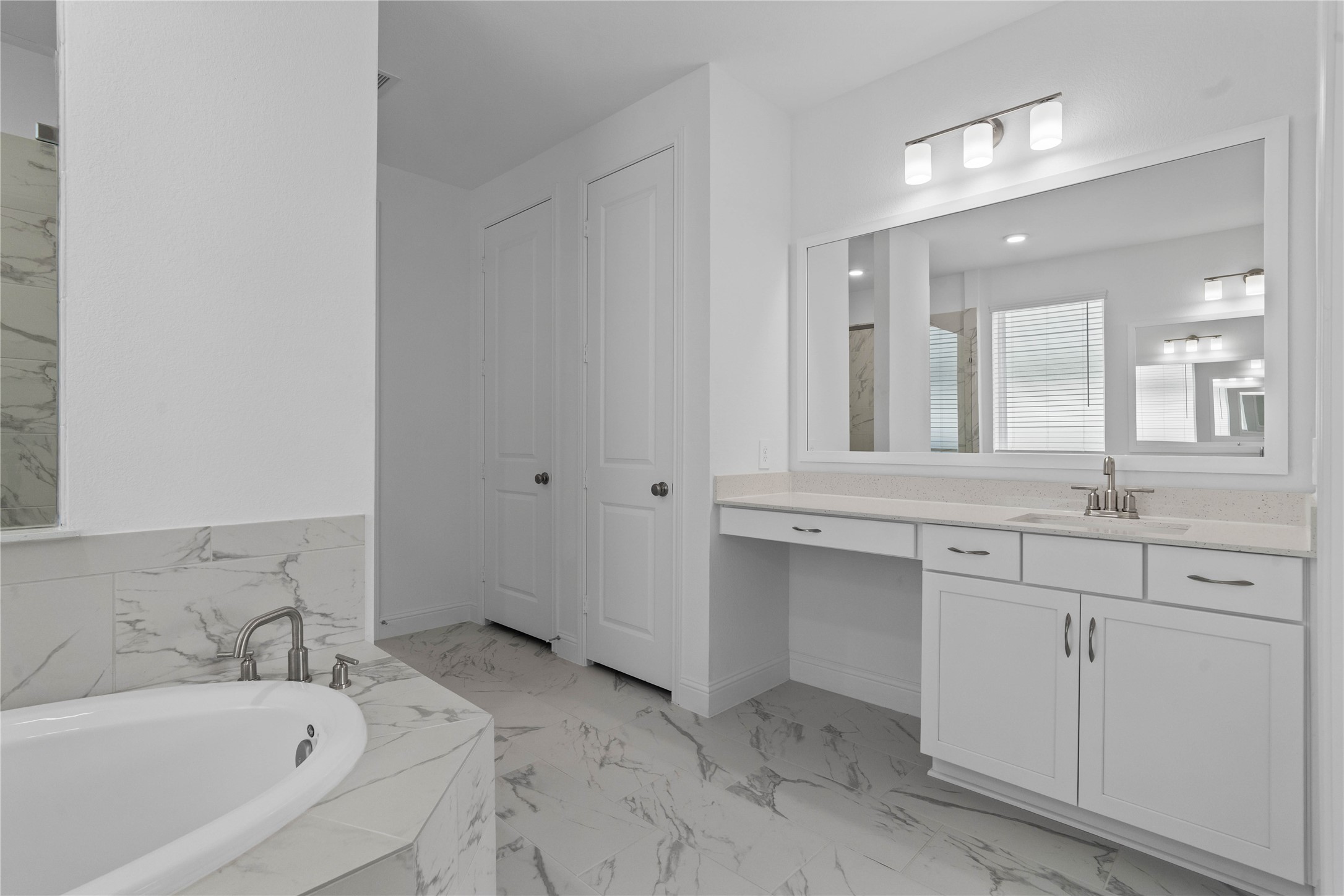 17315 July Moon Lane Conroe, TX 77302 - Photo 25 of 46 Modern primary bath features dual vanities with sleek cabinetry, quartz countertop, and crisp brushed nickel fixtures for a truly contemporary feel.