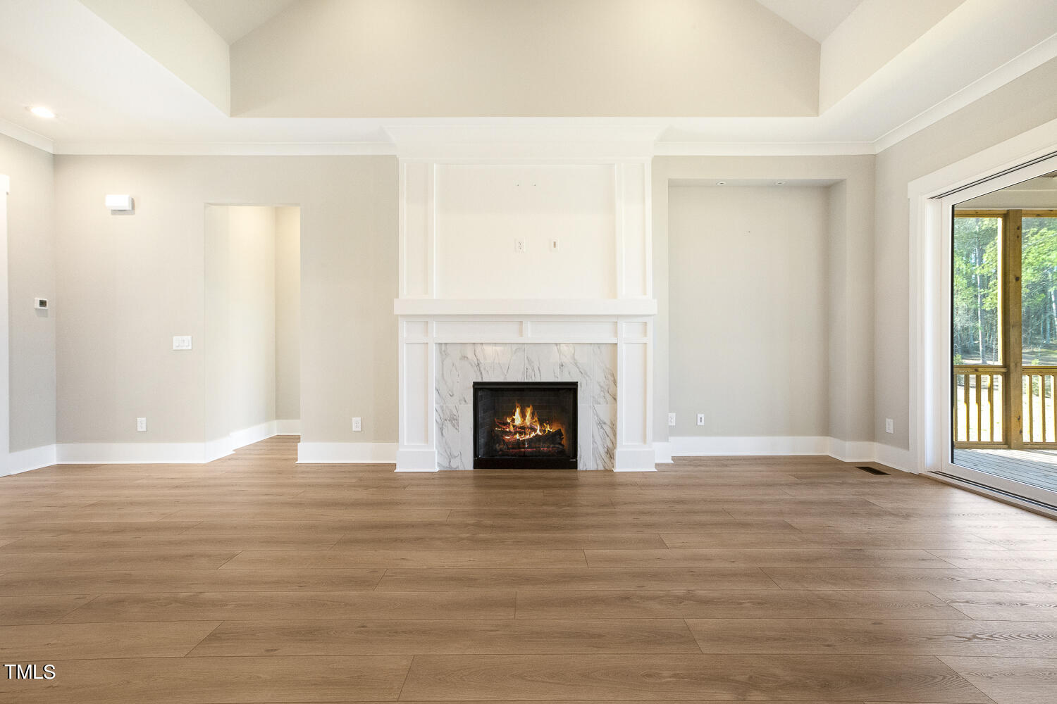 593 Pope Lake Road Angier, NC 27501 - Photo 13 of 48 a view of an empty room with wooden floor fireplace and a window