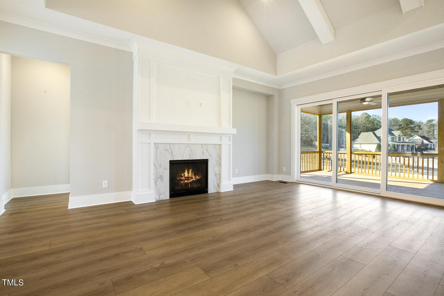 593 Pope Lake Road Angier, NC 27501 - Photo 14 of 48 a view of an empty room with wooden floor and a fireplace