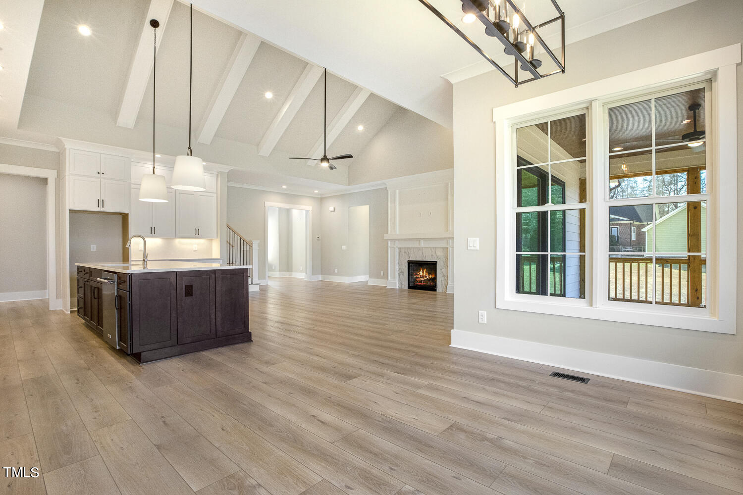 593 Pope Lake Road Angier, NC 27501 - Photo 26 of 48 a view of a kitchen with kitchen island a sink wooden floor and a large window