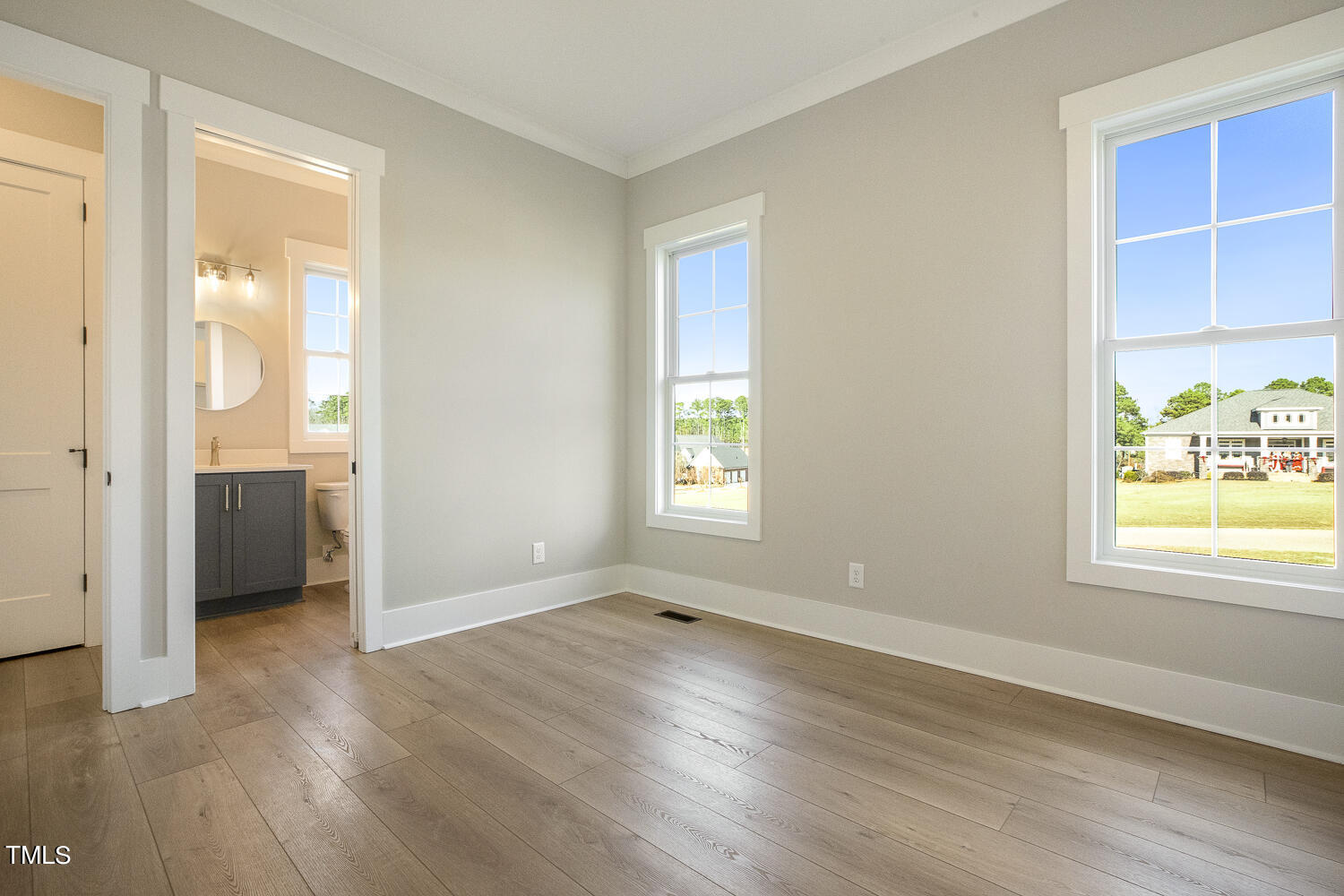 593 Pope Lake Road Angier, NC 27501 - Photo 34 of 48 an empty room with wooden floor and windows