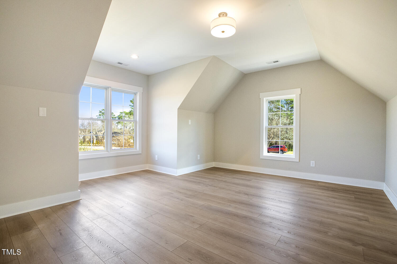 593 Pope Lake Road Angier, NC 27501 - Photo 43 of 48 an empty room with wooden floor and windows